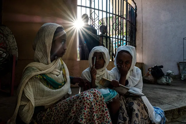 Ethiopian Orthodox girls play outside of St. George Church, in the city of Bahir Dar, Ethiopia, on November 19, 2020. (Photo by Eduardo Soteras/AFP Photo)