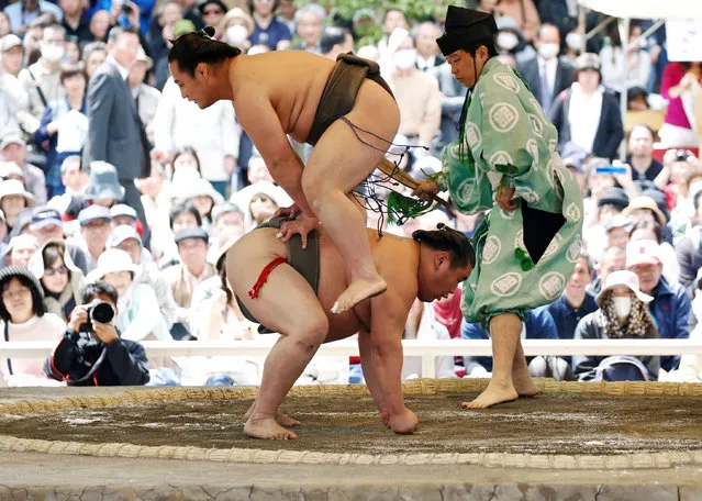 Sumo wrestlers perform a show fight during an annual sumo tournament dedicated to the Yasukuni Shrine in Tokyo, Japan. (Photo by Toru Hanai/Reuters)