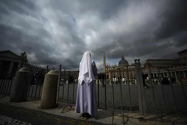 A nun stands at St. Peter's square on March 30, 2023 in The Vatican, a day after the Pope was admitted to the Gemelli hospital in Rome. Pope Francis has been diagnosed with a respiratory infection and will require “a few days of appropriate hospital medical treatment”, the Vatican said. The 86-year-old was admitted to Rome's Gemelli hospital for checks on March 29 after complaining of breathing difficulties, spokesman Matteo Bruni said in a statement. (Photo by Filippo Monteforte/AFP Photo)