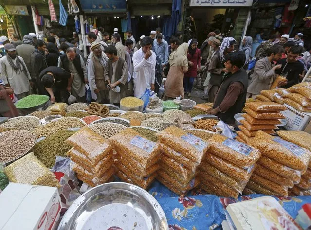 People shop for festive goods in preparation for the Eid al-Adha festival, in Kabul, Afghanistan September 23, 2015. (Photo by Omar Sobhani/Reuters)