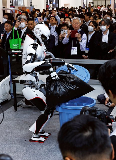 Kawasaki Heavy Industries' Robust Humanoid Platform Kaleido 9 throws a garbage bag in the trash can during its demonstration on the first day of the International Robot Exhibition 2025 at Tokyo Big Sight in Tokyo, Japan pn December 3, 2025. (Photo by Manami Yamada/Reuters)