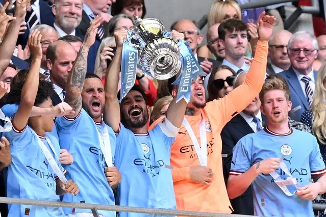 Manchester City's German midfielder Ilkay Gundogan (C) lifts the trophy after the English FA Cup final football match between Manchester City and Manchester United at Wembley stadium, in London, on June 3, 2023. Man City won the game 2-1. (Photo by Glyn Kirk/AFP Photo)