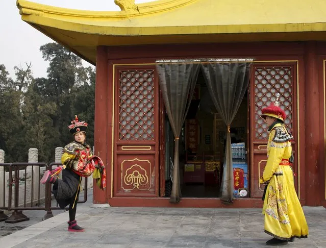 Clerks of a souvenir shop wearing traditional costumes play Chinese hacky sack game at the Temple of Heaven park in Beijing, China, December 19, 2015. (Photo by Kim Kyung-Hoon/Reuters)