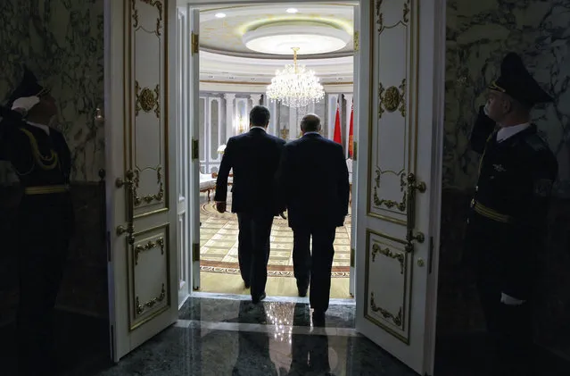 Belarus' President Alexander Lukashenko, right, and Ukraine's President Petro Poroshenko enter a hall in Minsk, Belarus, Wednesday, February 11, 2015. (Photo by Mykhailo Palinchak/AP Photo)