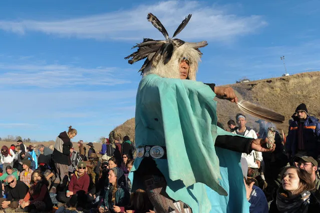 A man from the Havasupai tribe blesses people participating in a prayer circle near Turtle Island during a protest against plans to pass the Dakota Access pipeline near the Standing Rock Indian Reservation, near Cannon Ball, North Dakota, U.S. November 26, 2016. (Photo by Stephanie Keith/Reuters)