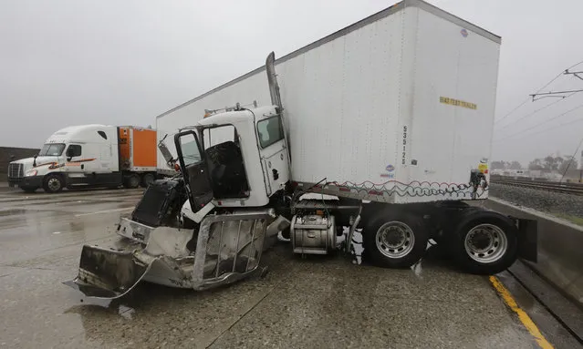 Authorities investigate a multi-vehicle crash involving a semi-truck in the westbound lane of Foothill 210 Freeway at Sierra Madre Blvd., Tuesday, January 5, 2016, in Pasadena, Calif. Persistent wet conditions could put some Los Angeles County communities at risk of flash flooding along with mud and debris flows, especially in wildfire burn areas. El Nino storms lined up in the Pacific, promising to drench parts of the West for more than two weeks and increasing fears of mudslides and flash floods in regions stripped bare by wildfires. (Photo by Damian Dovarganes/AP Photo)