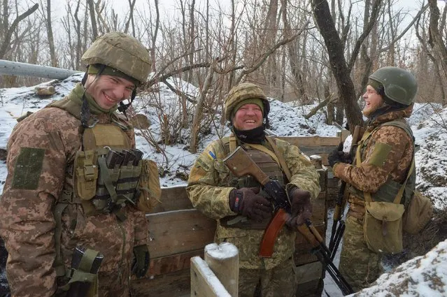 Ukrainian service members react while standing at fighting positions on the contact line with Russian-backed separatist rebels near the town of Avdiivka in Donetsk Region, Ukraine on February 13, 2021. (Photo by Oleksandr Klymenko/Reuters)