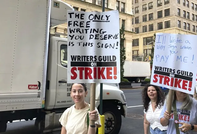 Picketers carry signs outsie of Netflix on Wednesday, August 9, 2023, in New York. The Hollywood writers strike reached the 100-day mark today as the U.S. film and television industries remain paralyzed by dual actors and screenwriters strikes. (Photo by Jocelyn Noveck/AP Photo)