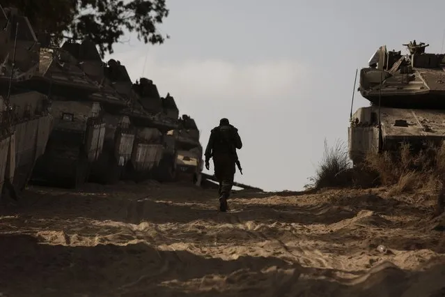 An Israeli soldier walks at a staging ground near the border with the Gaza Strip, in southern Israel, Thursday, May 20, 2021. (Photo by Maya Alleruzzo/AP Photo)