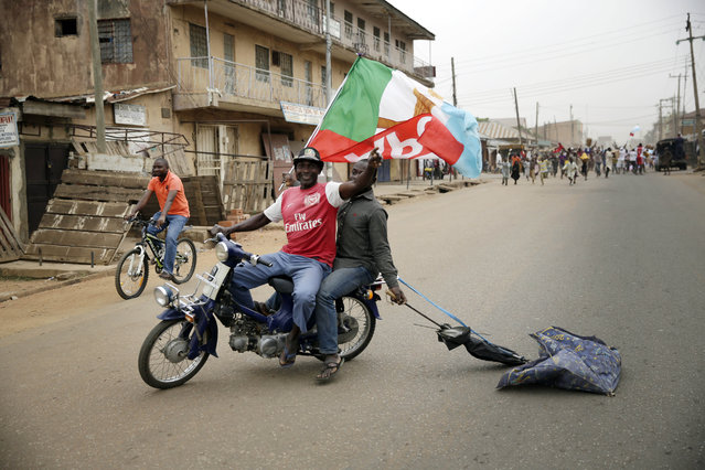 Residents celebrate the anticipated victory of Presidential candidate Muhammadu Buhari  in Kaduna,  Nigeria Tuesday, March 31, 2015. The spokesman for retired Gen. Muhammadu Buhari says the former military dictator has won Nigeria's bitterly contested presidential election but fears “tricks” from the government. Garba Shehu told The Associated Press that their polling agents across the country tell them they have succeeded in defeating President Goodluck Jonathan”. (Photo by Jerome Delay/AP Photo)