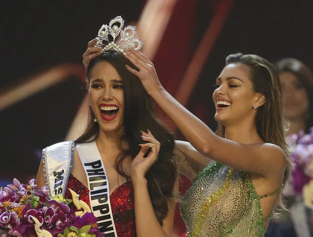Catriona Gray of the Philippines, left, reacts as she is crowned the new Miss Universe 2018 by Miss Universe 2017 Demi-Leigh Nel-Peters during the final round of the 67th Miss Universe competition in Bangkok, Thailand, Monday, December 17, 2018. (Photo by Gemunu Amarasinghe/AP Photo)