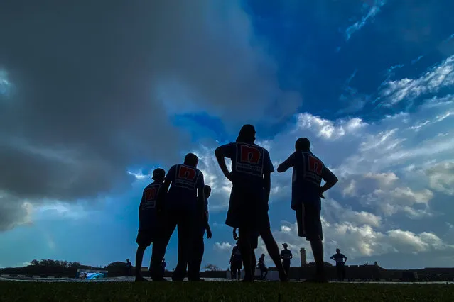 Ground staff cover the pitch as rain stops the play during the second day of the first cricket Test match between Sri Lanka and Pakistan at the Galle International Cricket Stadium in Galle on July 17, 2023. (Photo by Ishara S. Kodikara/AFP Photo)