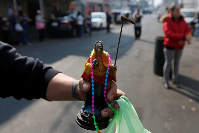 A figurine of Santa Muerte or The Saint of Death is pictured during the first prayer of the New Year in Mexico City, Mexico January 1, 2017. (Photo by Carlos Jasso/Reuters)