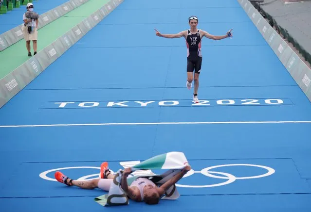 Gold medalist Kristian Blummenfelt of Norway and silver medalist Alex Yee of Britain celebrate finishing in the men's individual triathlon competition during the Tokyo 2020 Olympic Games at the Odaiba Marine Park in Tokyo on July 26, 2021. (Photo by Hannah Mckay/Reuters)