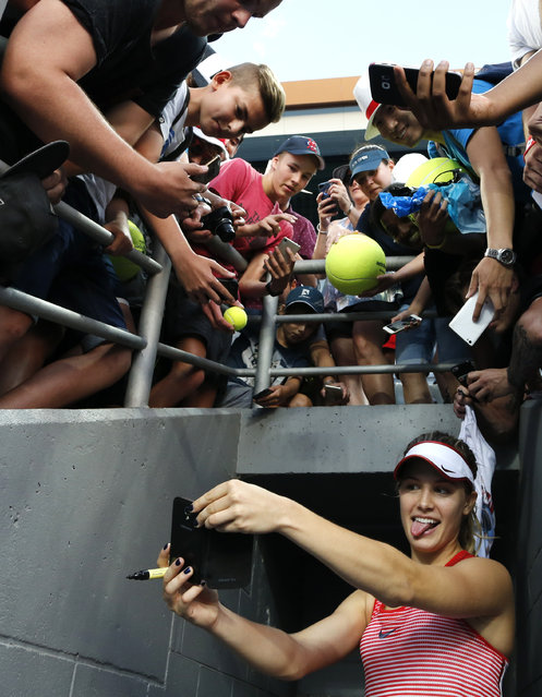 Eugenie Bouchard of Canada takes a selfie for a fan after defeating Aleksandra Krunic of Serbia during their first round match at the Australian Open tennis championships in Melbourne, Australia, Monday, January 18, 2016. (Photo by Shuji Kajiyama/AP Photo)