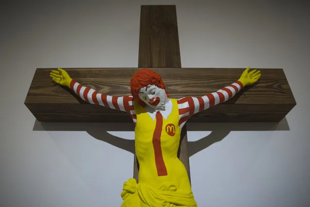 An artwork called “McJesus”, which was sculpted by Finnish artist Jani Leinonen and depicts a crucified Ronald McDonald, is seen on display as part of the Haifa museum's “Sacred Goods” exhibit, in Haifa, Israel, Monday, January 14, 2019. Hundreds of Christians calling for the sculpture's removal protested at the museum last week. (Photo by Oded Balilty/AP Photo)