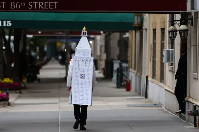 A man wearing a costume of New York's Metropolitan Life Insurance Company Tower walks down West 86th street in the Upper West Side neighborhood of Manhattan on Halloween day in New York City, New York, U.S., October 31, 2022. (Photo by Mike Segar/Reuters)