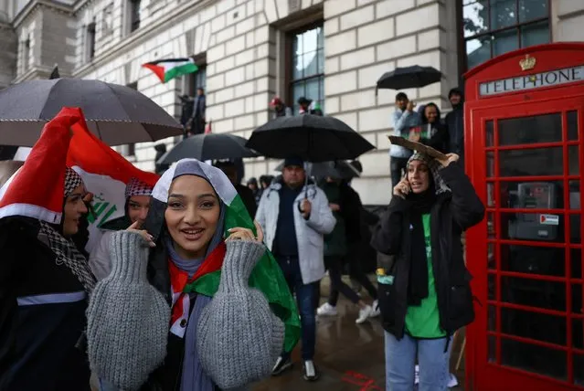 A woman wearing a Palestinian flag takes part in a protest in solidarity with Palestinians in Gaza, amid the ongoing conflict between Israel and the Palestinian Islamist group Hamas, in London, Britain on October 21, 2023. (Photo by Hannah McKay/Reuters)