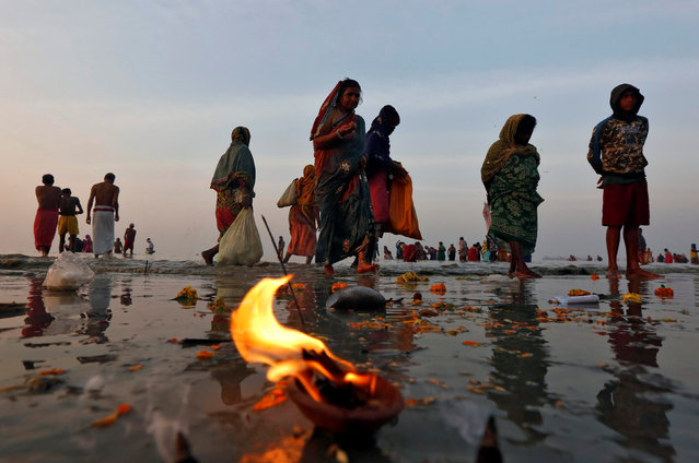 Hindu pilgrims walk after taking a dip at the confluence of the river Ganges and the Bay of Bengal a day after “Makar Sankranti” festival at Sagar Island, south of Kolkata, India, January 15, 2017. (Photo by Rupak De Chowdhuri/Reuters)