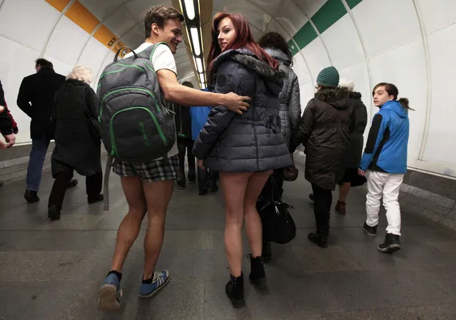 Passengers, not wearing pants, walk through a subway train transfer tunnel during the “No Pants Subway Ride” in Prague January 12, 2014. (Photo by David W. Cerny/Reuters)