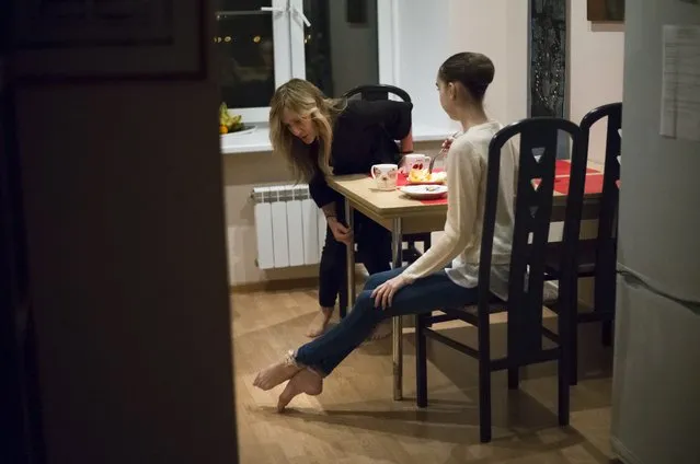 In this photo taken on Tuesday, March  1, 2016, Harper Ortlieb, from Mount Hood, Oregon, has dinner with her mother Layne Baumann, left, at home after classes at the Bolshoi Ballet Academy in Moscow, Russia. (Photo by Alexander Zemlianichenko/AP Photo)