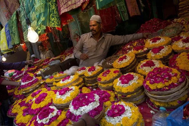 Indian muslims sell petals and garlands to devotees for offering at the shrine of Sufi saint Khwaja Moinuddin Chishti during the Urs festival in Ajmer, in the western Indian state of Rajasthan, India, Friday, April 24, 2015. Thousands of pilgrims from different parts of India have arrived in the city for the yearly Urs that marks the death anniversary of the sufi saint. (Photo by Bernat Armangue/AP Photo)