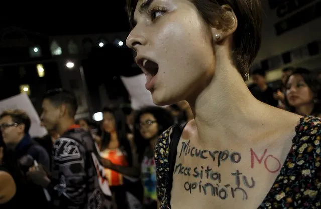 An activist with the phrase “My body does not need your opinion” written on her chest takes part in a protest to mark International Women's Day in San Jose, Costa Rica March 8, 2016. (Photo by Juan Carlos Ulate/Reuters)