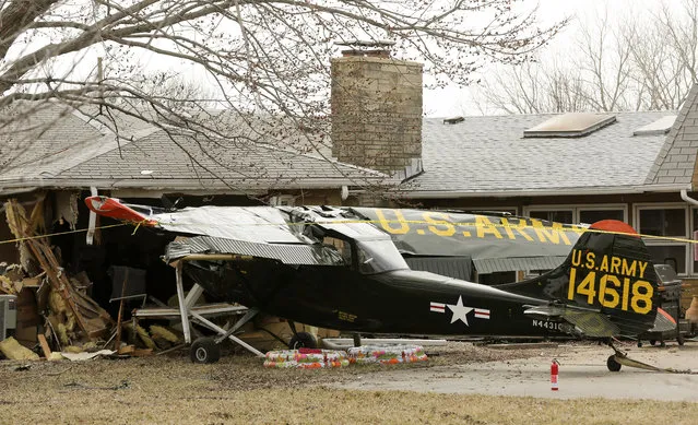 A small plane crashed while landing at Stearman Field near Benton, Kan. on Monday, March 11, 2019. The airplane crashed into a porch of an empty house which sustained structural damage. The two people aboard the plane had minor injuries. (Photo by Jaime Green/The Wichita Eagle via AP Photo)