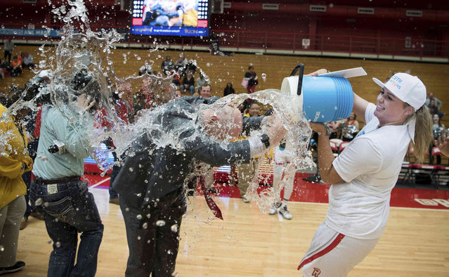 Radford forward Laney Corbin (42) douses coach Mike McQuire while celebrating after the team's win over Campbell during an NCAA college basketball game for the Big South women's tournament championship in Radford, Va., Sunday, March 17, 2019. (Photo by Lee Luther Jr./AP Photo)