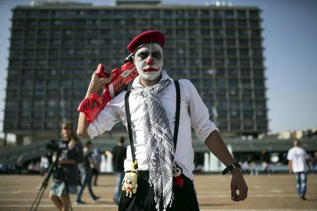 An Israeli Arab wearing make-up takes part in a protest against housing shortage and house demolitions in Arab communities, in Tel Aviv's Rabin Square, Israel April 28, 2015. (Photo by Baz Ratner/Reuters)