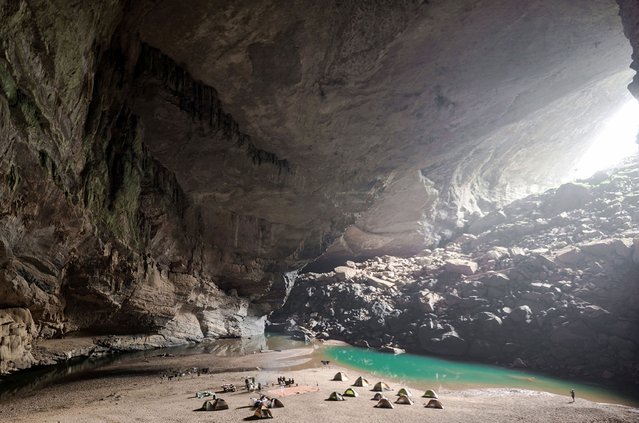The campers set up inside the cave on the beach. (Photo by Lars Krux/Caters News)