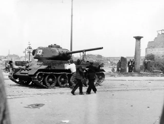 Demonstrators hurl stones at Soviet tanks on Leipziger Platz in East Berlin, Germany on June 17, 1953. Germany's parliament on Friday, June 16, 2023, commemorated the 70th anniversary of a popular uprising in the communist east that was brutally crushed by the Soviet-backed dictatorship. (Photo by Thomas Reiche/AP Photo, File)