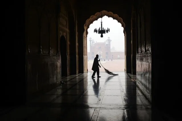 A Muslim man cleans a corridor at Badshahi mosque ahead of the Islamic holy fasting month of Ramadan in Lahore on March 11, 2024. (Photo by Syed Murtaza/AFP Photo)