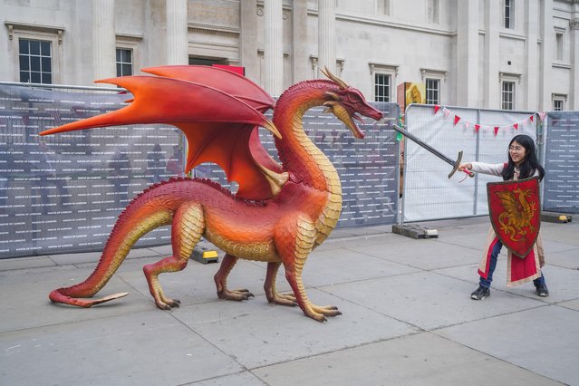 A young girl dressed as Saint George pretends to slain the dragon with a sword during the Saint Saint George's Day celebrations in Trafalgar Square in London on April 21, 2024. (Photo by Amer Ghazzal/Alamy Live News)
