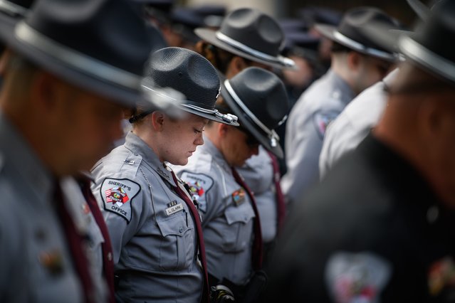 Law enforcement officers bow their heads during the invocation at the Peace Officers Memorial Service at the Cumberland County Courthouse in Fayetteville, N.C., on Thursday, May 16, 2024. (Photo by Andrew Craft/USA TODAY Network)