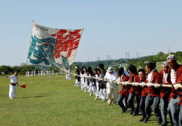 Participants fly Japan's largest kite, measuring 14.5x14.5 meters and weighing 950 kg, during the Oodako Matsuri, a giant kite festival, in Sagamihara, south of Tokyo, Japan on May 4, 2024. The annual festival has been passed down for more than a century as a form of prayer to help ensure a good harvest. (Photo by Kim Kyung-Hoon/Reuters)