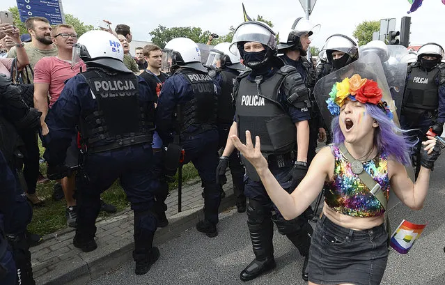 LGBT activists and their supporters gather for the first-ever pride parade in the central city of Plock, Poland, on Saturday August 10, 2019. The parade comes as the country finds itself bitterly divided over the growing visibility of the LGBT issue and as the government and powerful Catholic church denounce gay rights as a threat to society. (Photo by Czarek Sokolowski/AP Photo)