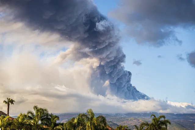 A photo shows the Mount Etna volcano spewing smoke on December 14, 2021 in Catania, Italy. (Photo by Salvatore Allegra/Anadolu Agency via Getty Images)