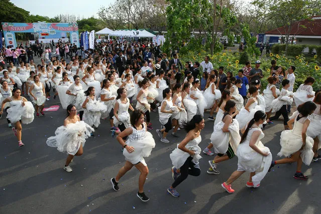 Brides-to-be participate in the “Running of the Brides” race in a park in Bangkok, Thailand March 25, 2017. (Photo by Athit Perawongmetha/Reuters)