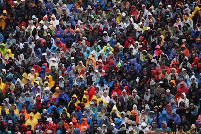 Fans in rain macs during the F1 Grand Prix of Canada at Circuit Gilles Villeneuve on June 09, 2024 in Montreal, Canada. (Photo by Andy Hone/LAT Images)