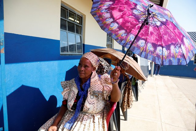 A woman holds an umbrella during the South African elections, in Nkandla, South Africa on May 29, 2024. (Photo by Rogan Ward/Reuters)