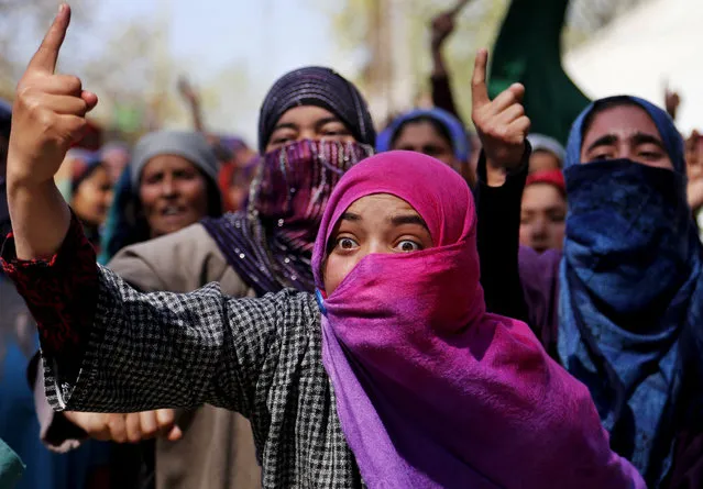 A Kashmiri woman shouts pro freedom slogans during the funeral of Umer Farooq, a Kashmiri civilian who was killed Sunday at Baroosa village 34 Kilometers (21 miles) northeast of Srinagar, Indian controlled Kashmir, Monday, April 10, 2017. Government forces opened fire on Sunday on crowds of people who attacked polling stations during a by-election for a vacant seat in India's Parliament, killing eight people. (Photo by Mukhtar Khan/AP Photo)