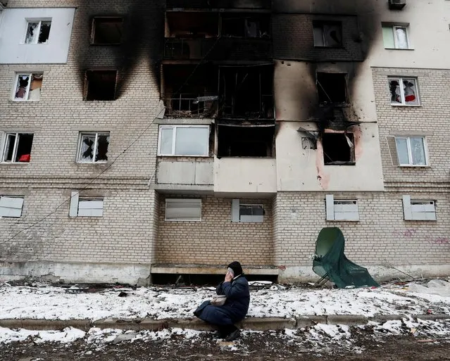 A woman reacts in front of a residential building which was damaged during Ukraine-Russia conflict in the separatist-controlled town of Volnovakha in the Donetsk region, Ukraine March 11, 2022. (Photo by Alexander Ermochenko/Reuters)