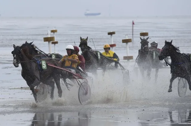 Competitors race on mud flats during their tideland race (Wadden Race) in Duhnen, Lower Saxony, Germany, July 12, 2015. (Photo by Fabian Bimmer/Reuters)