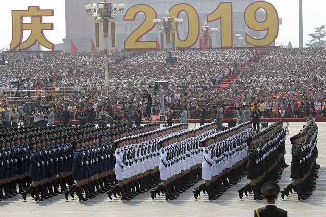 Members of a Chinese military honor guard march during the the celebration to commemorate the 70th anniversary of the founding of Communist China in Beijing, Tuesday, October 1, 2019. (Photo by Ng Han Guan/AP Photo)