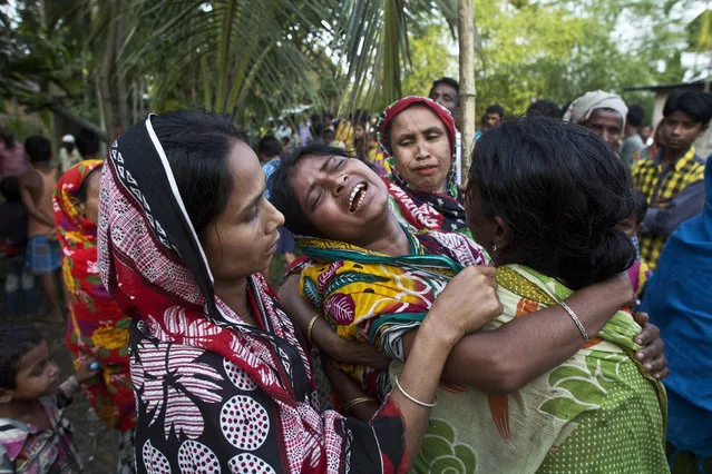 Relatives of Abu Hanif, who was beaten to death by a mob on Sunday night, wail during his funeral in Naramari village, about 140 kilometers east of Gauhati, in the northeastern Indian state of Assam, Monday, May 1, 2017. Two Muslim men, including Hanif, were beaten to death by a mob in northeastern India over allegations of cow theft, the latest in a series of similar attacks across the country, police officials said Monday. Human Rights Watch said in a report last week that since Prime Minister Narendra Modi's government took office at least 10 Muslims, including a 12-year-old boy, have been killed in mob attacks in seven separate incidents related to allegations over cows. (Photo by Anupam Nath/AP Photo)
