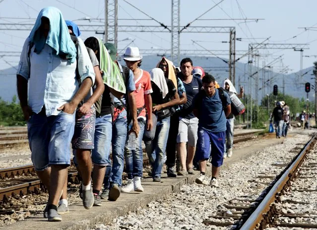 Migrants walk towards the train station in Gevgelija July 19, 2015. (Photo by Ognen Teofilovski/Reuters)