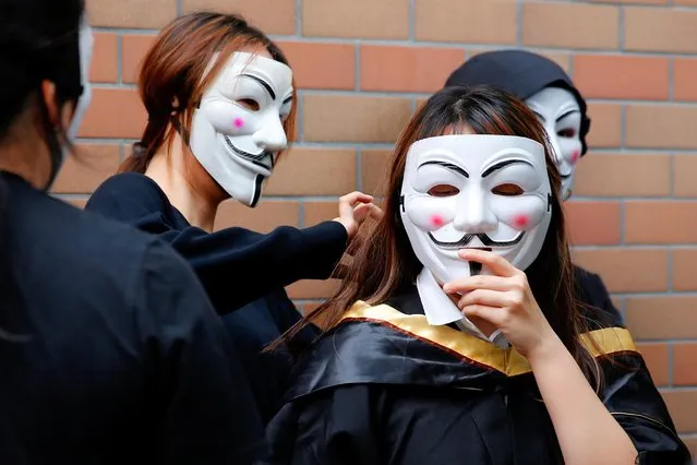 University students wearing Guy Fawkes masks pose for a photoshoot of a graduation ceremony to support anti-government protests at the Hong Kong Polytechnic University, in Hong Kong, China on October 30, 2019. (Photo by Tyrone Siu/Reuters)