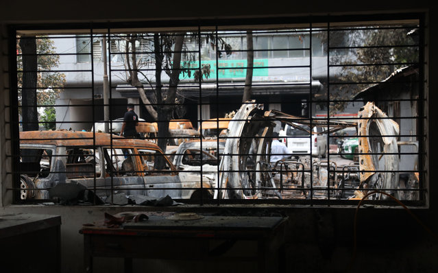 Burnt vehicles are seen inside a government building after the protests in Dhaka, Bangladesh, 22 July 2024. On 22 July Bangladesh was under curfew; widespread disruption of telecoms prevailed a day after the Bangladesh Supreme Court scrapped some quotas for government jobs that sparked protests, and police were authorized to enforce 'shoot on sight' orders across the country during curfew as casualties mounted and law enforcement struggled to contain the unrest. The Bangladeshi government imposed a nationwide curfew and deployed military forces after violence broke out in Dhaka and other regions following student-led protests demanding reforms to the government's job quota system. (Photo by Monirul Alam/EPA/EFE)