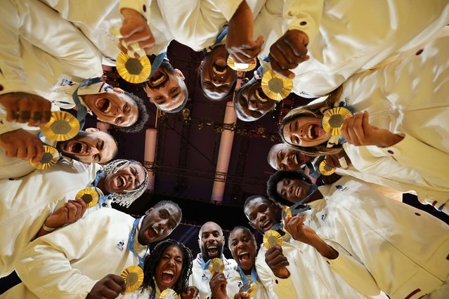 Gold medallists team France pose for a photo after the podium of the judo mixed team event at the Paris 2024 Olympic Games in the Champ-de-Mars Arena, in Paris on August 3, 2024. (Photo by Jack Guez/AFP Photo)